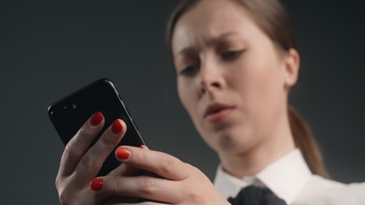 Woman Reading a Message on a Smartphone