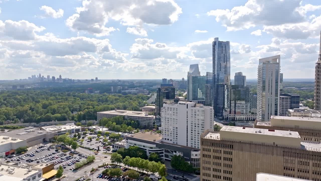 Buckhead highrise and skyline buildings under sunny sky, Atlanta, Georgia, Drone shot