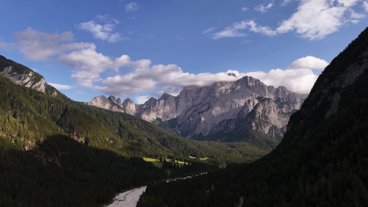 Aerial drone shot of the Alps on a sunny day with clear skies and bright mountain peaks