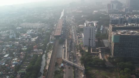 sunrise aerial shot of highway in chennai city filled with misty fog