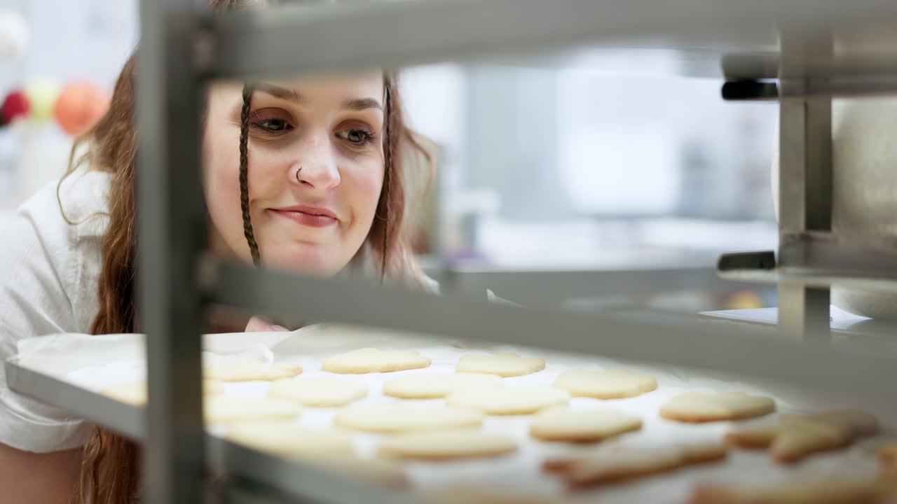 Bakery, kitchen and happy woman with cookies