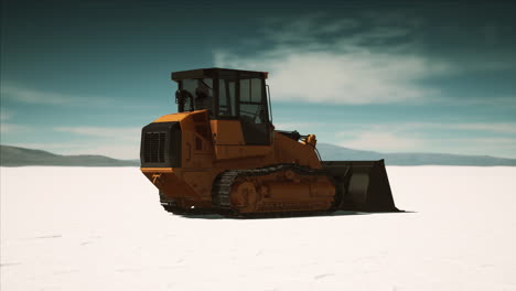 road grading machine on the salt desert road
