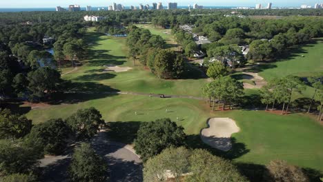 a sight of a verdant golf course - aerial panning