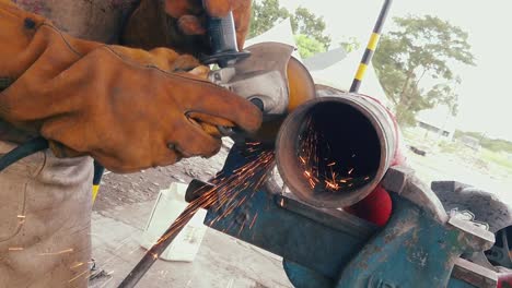 blacksmith or welder professional, smooths steel and iron,in extreme slow motion,to make the surface smooth