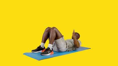 african man on a mat doing roll up exercise