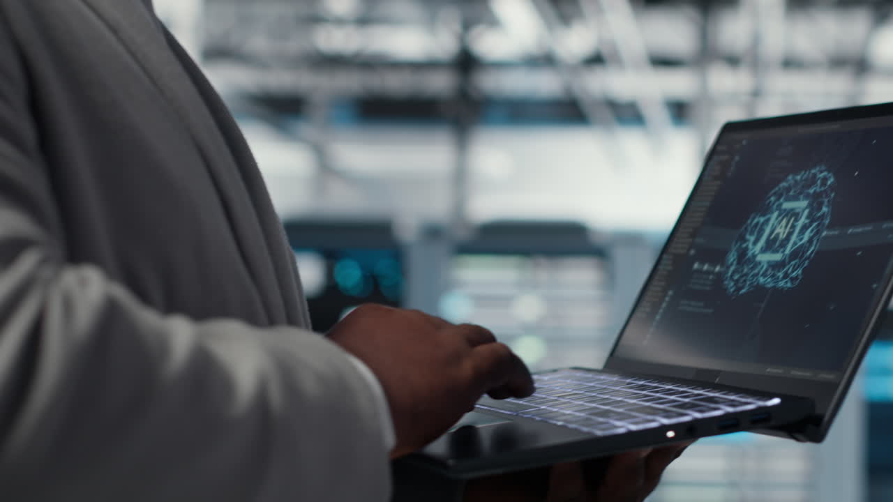 Server farm IT expert using laptop to improve deep learning AI systems, closeup