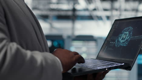 server farm it expert using laptop to improve deep learning ai systems, closeup