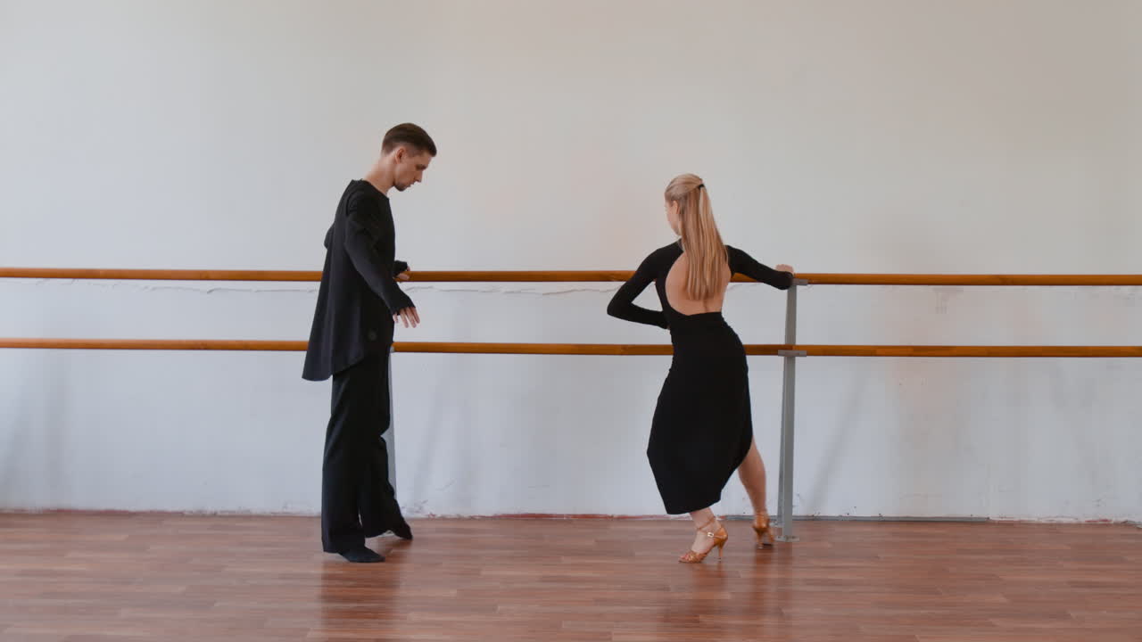 Two Dancers Practicing in a Studio with a Ballet Barre