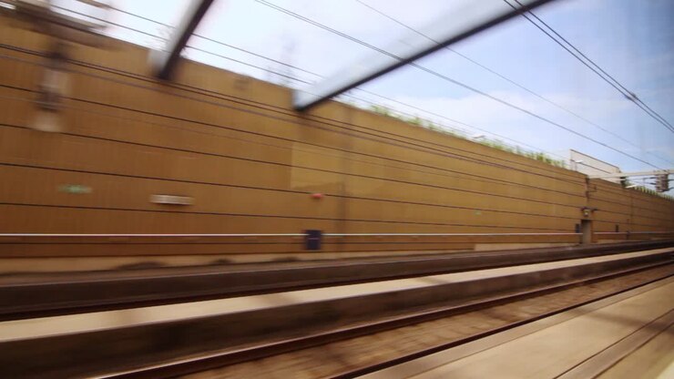 View from train moving fast in tunnel to railway stations