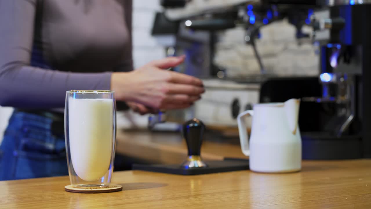 Barista working at bar counter in cafe. Professional barista standing at bar counter in coffee shop