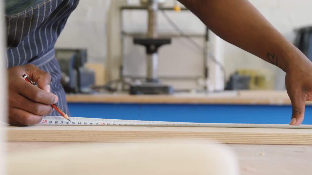 Carpenter marking with pencil on wood 4k