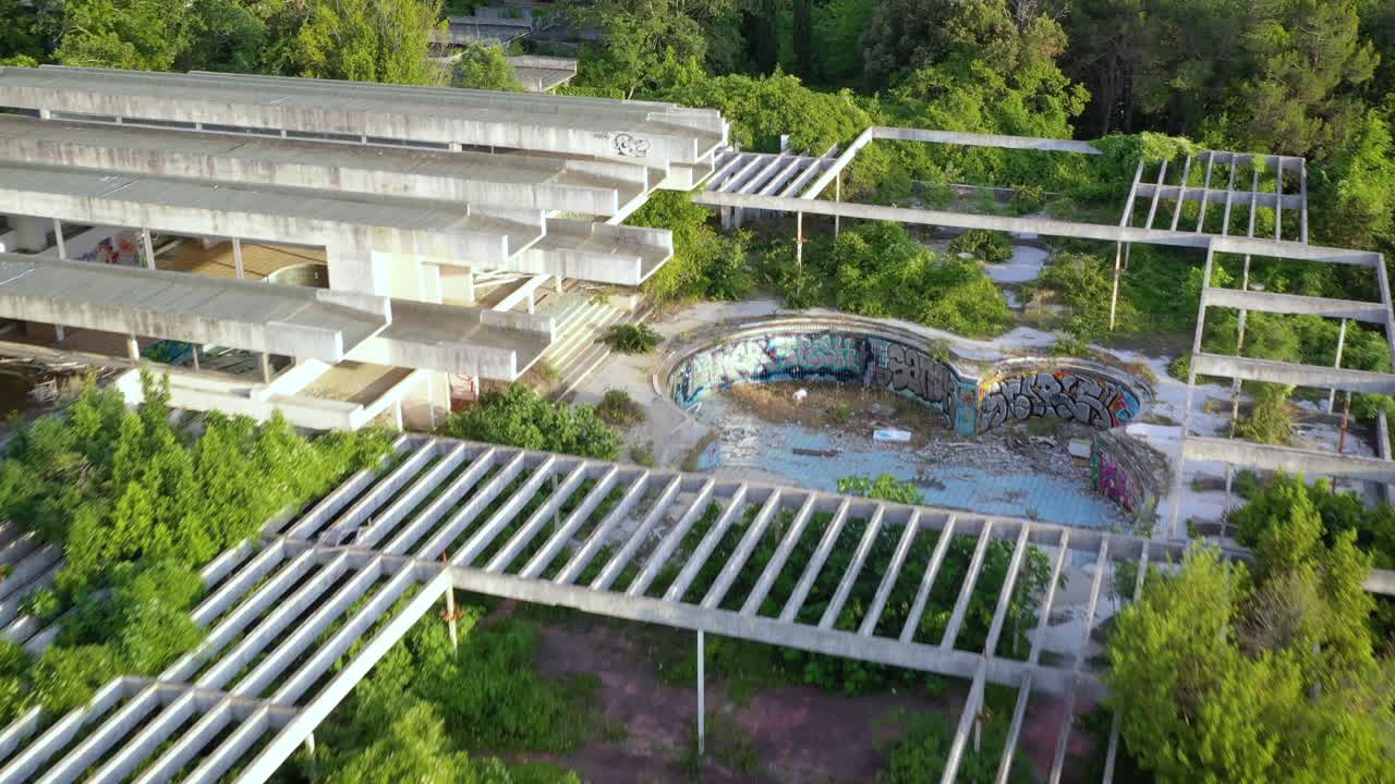 Aerial: Flying over remains of Haludovo Palace Hotel which is an abandoned luxurious resort hotel on the Croatian island Krk