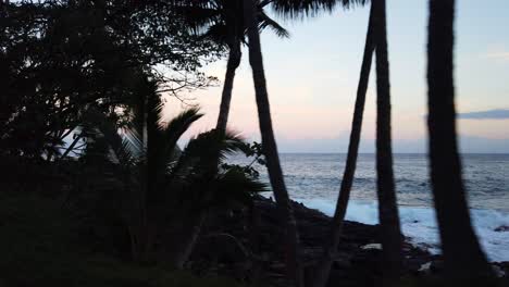 Slow-motion-drive-by-of-black-rock-beach-at-sunset-on-Hawaii