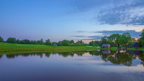 a sunrise timelapse over a picturesque pond with a cottage