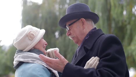 an elderly couple sharing a tender moment outdoors