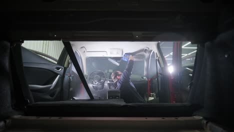 professional car cleaning. сar wash. interior detailing. dry clean and detail a car interior. deep seats cleaning. wiping foam in car wash. cleaning the car panel from dust. a vacuum cleaner