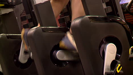 person exercising on a gym spinning bike