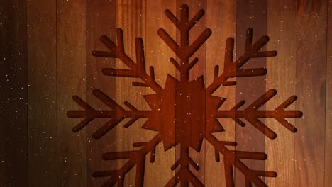 Video-composition-with-snow-over-Christmas-ornaments-on-wood