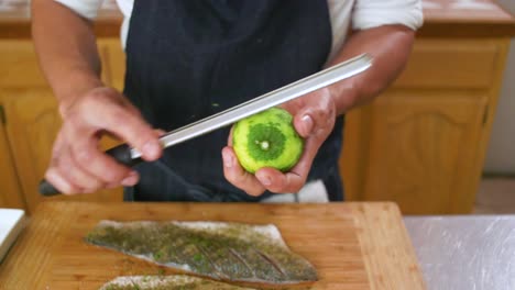 chef adding more limon zest onto fish