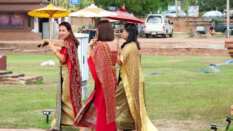 tourists walking in ayutthaya wearing traditional thai attire