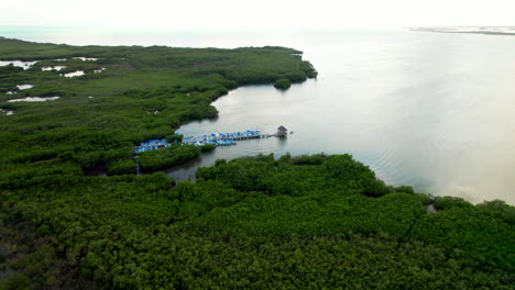 drone fly above tourist dock for guided ferry cruise tour in tulum sian kaʼan reserve a biosphere reserve quintana roo mexico