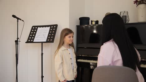 a woman teaches a little girl to sing sharing a musical bond a touching scene unfolds as a woman teaches a little girl to sing in a cozy musicfilled space where the girl sings confidently eyes shining