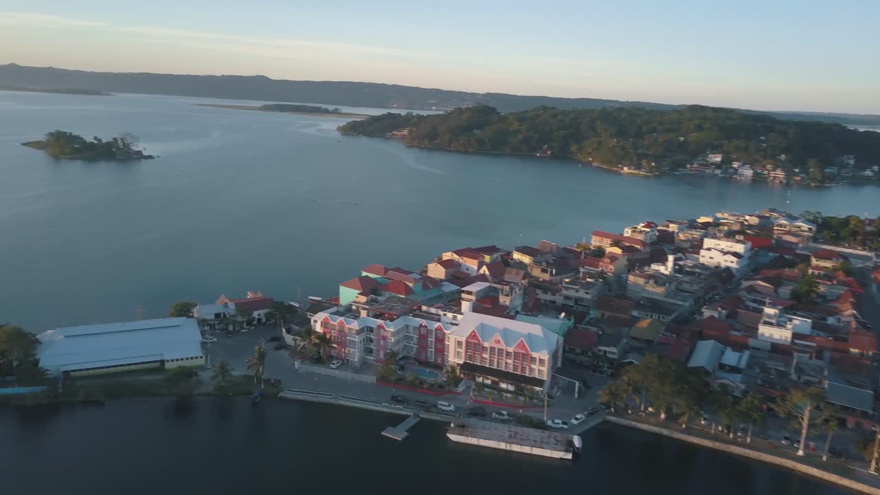 Beautiful aerial drone shot of Flores island bridge in the middle of lake Peten Itza, Guatemala