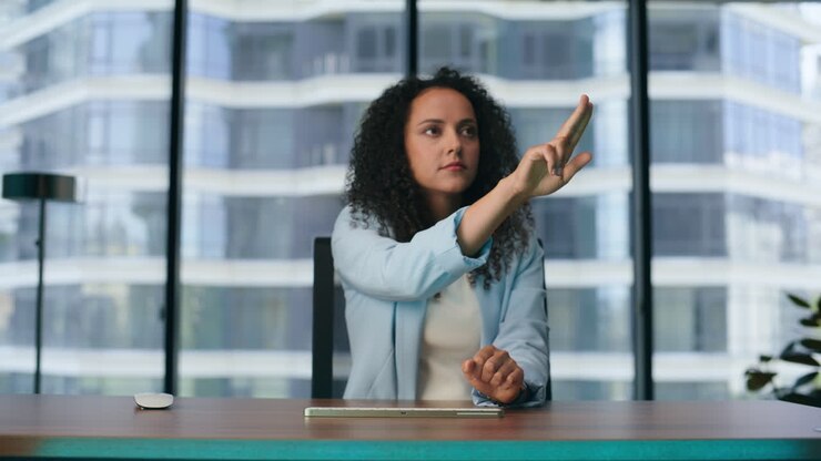 Woman using augmented reality software interface for business in office close up