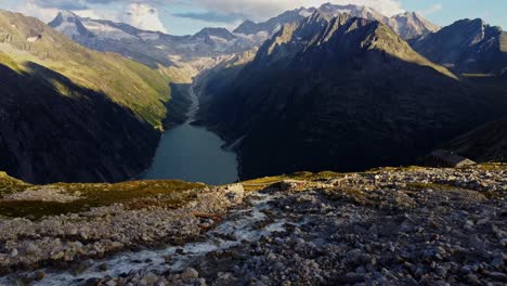 Downward-drone-shot-to-the-"Panoramabrücke"-a-famous-suspension-bridge-with-a-stunning-view-of-Schlegeis-Stausee-below