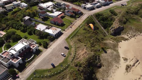 Paragliding-site-at-tourist-destination-of-beachfront-villas-and-resorts-in-La-Pedrera-village-on-Atlantic-Coast,-Uruguay