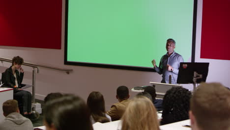 teacher in lecture theatre presenting to students, pan, shot on r3d