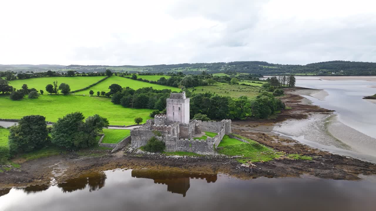 Beautiful aerial reveal of Doe Castle building in Donegal, Ireland. Moody afternoon