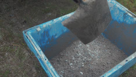 Shoveling-sand-and-gravel-off-truck-bed-into-bucket-TILT-SHOT