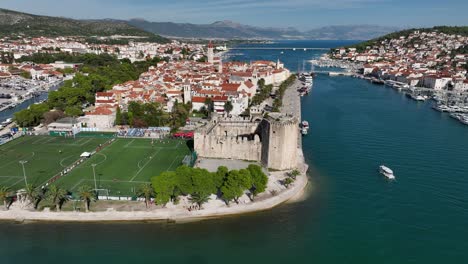 batarija football stadium next to kamerlengo castle in trogir, croatia. aerial pullback shot