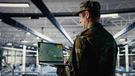 military technician in data center tracking satellite coordinates using notebook