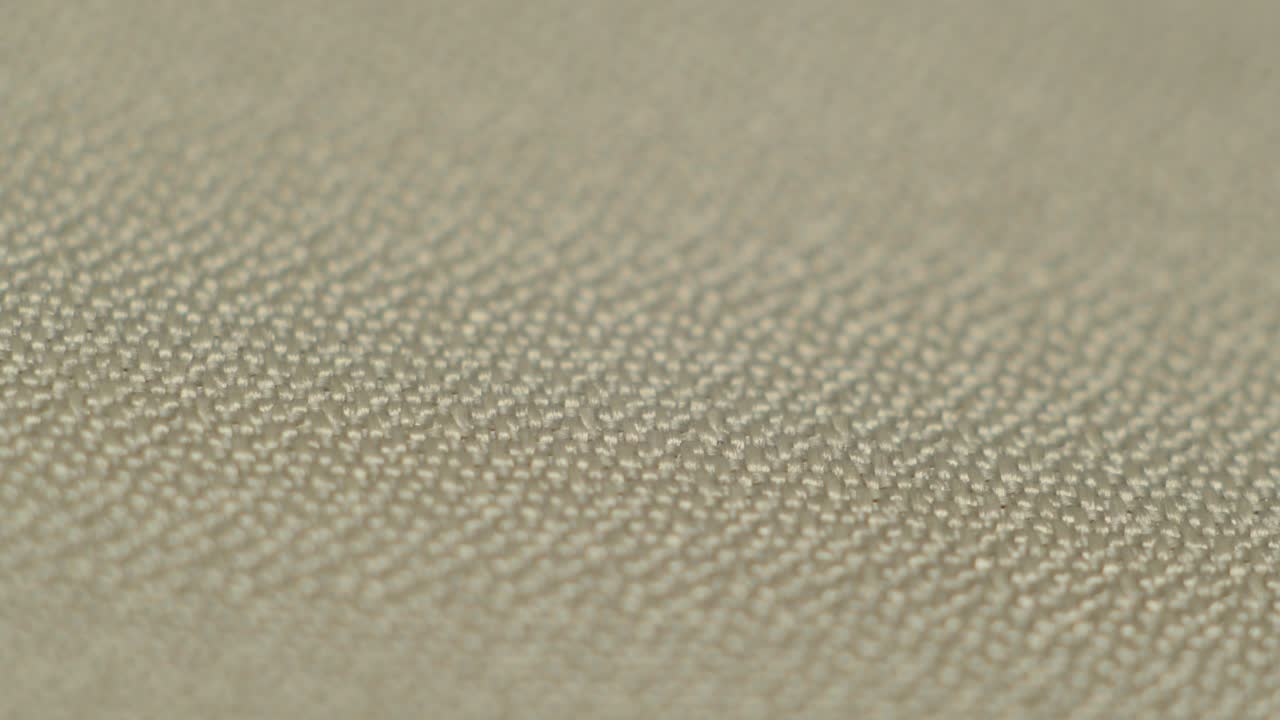 Close-up macro of beige stone showing natural mineral texture and smooth tone. Ideal for material studies and backgrounds