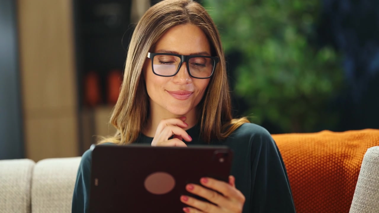 Smiling Woman Using Digital Tablet at Home
