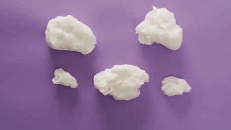 Video-of-marshmallows-pieces-lying-on-purple-surface