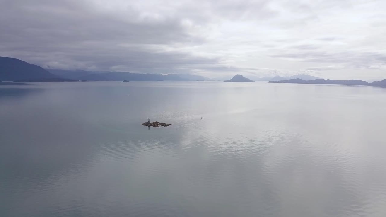 Extreme Wide Aerial View of Vanderbilt Reef with Diver's Boat Anchored, Sunset, and Alaska Mountain Range, Juneau AK