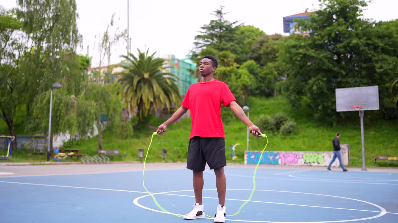 Man exercising with a jump rope outdoors