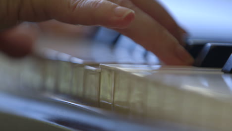 close up of musician's hands playing the piano.