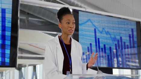 female scientist addressing the audience at a seminar