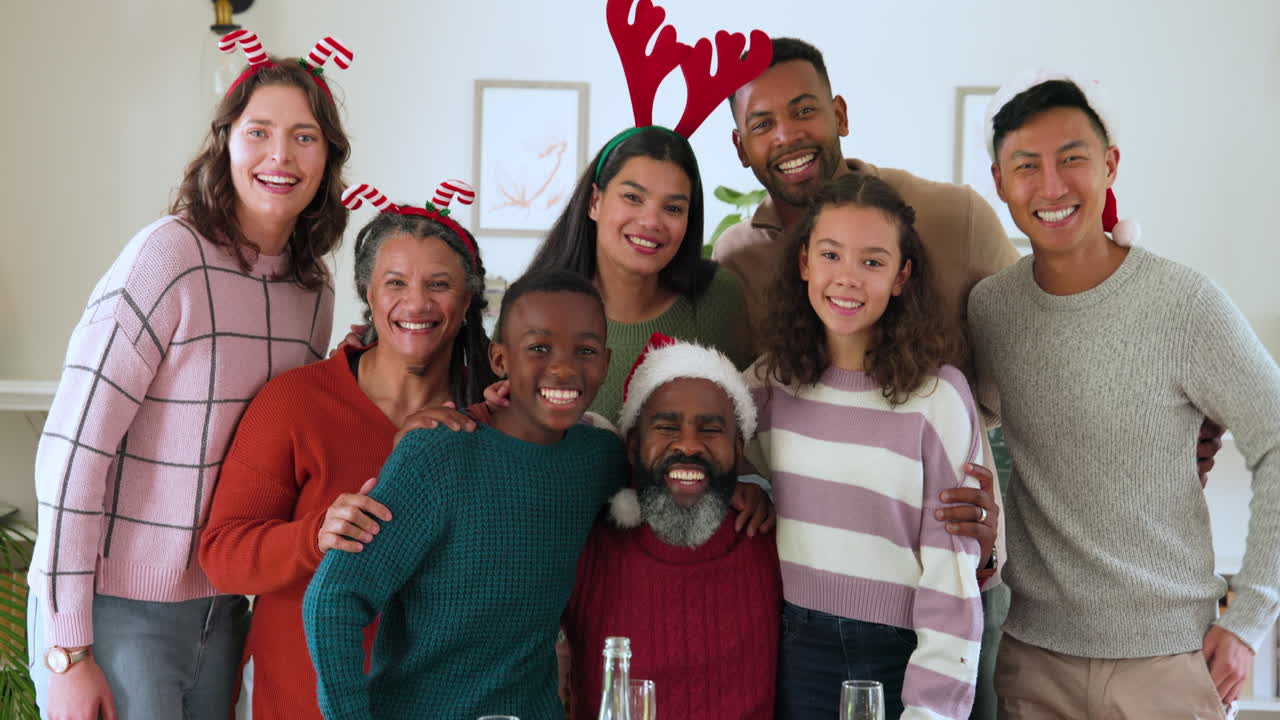 Celebrating Christmas, diverse family wearing festive hats and smiling joyfully at home