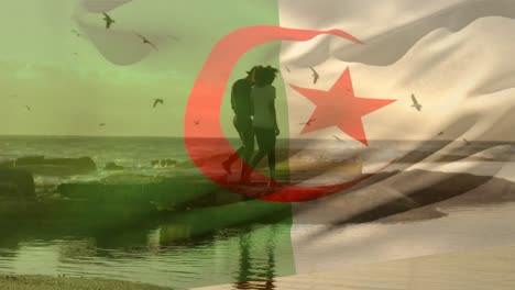 animation of flag of algeria over african american couple at beach