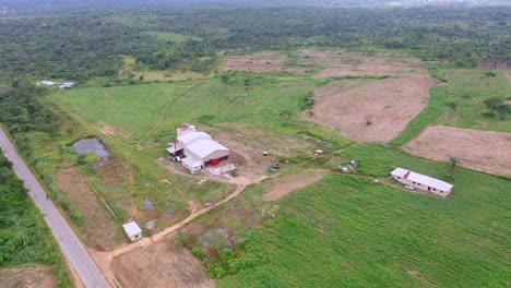 shot of a garri processing factory with worker and tractors