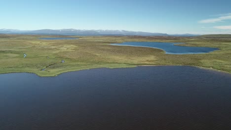 scenic flight over a lush green plain with lakes and rivers