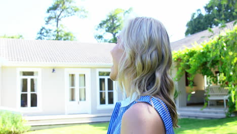 portrait of woman smiling in front of a house