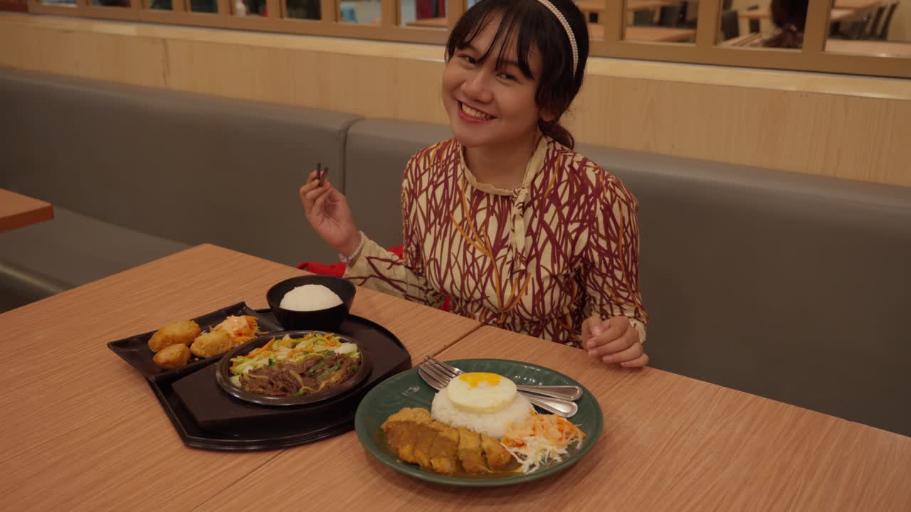 Happy Indonesian Girl (Foodie, Tourist, Traveler) Ready To Eat Delicious Asian Food With Chopsticks At A Japanese Restaurant.