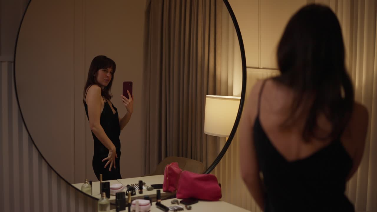 Woman taking a selfie in front of a mirror