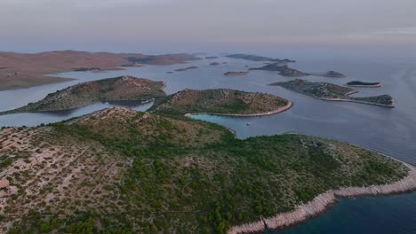 wide aerial shot of kornati islands at dusk, scattered in the calm adriatic sea, croatia.